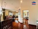 Spacious living area with wooden flooring and large windows