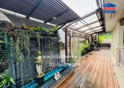 outdoor patio with wooden deck and water fountain