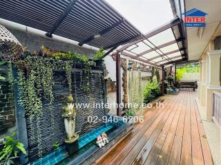 outdoor patio with wooden deck and water fountain