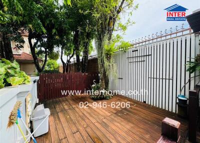 Spacious wooden deck with greenery and privacy fence