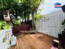 Spacious wooden deck with greenery and privacy fence