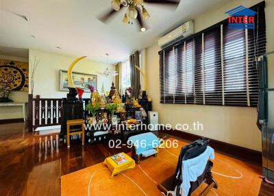 Living room with wooden floor and various decorations