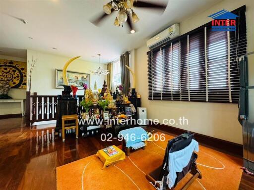 Living room with wooden floor and various decorations