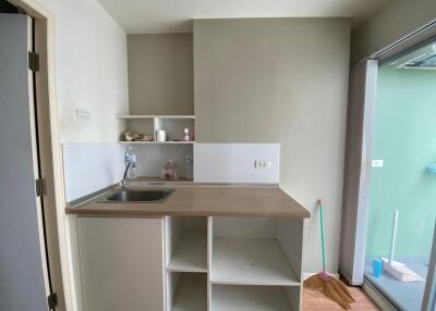 Small kitchen with sink and open shelving