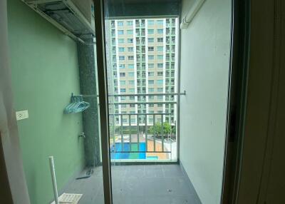 View of a balcony with railing and cityscape in the background