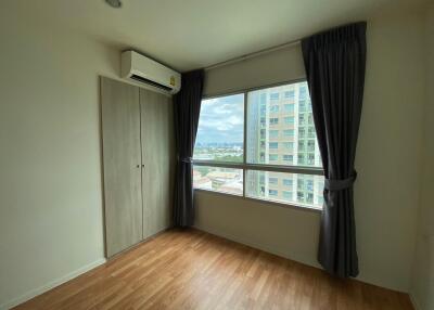 Bedroom with large window, closet, and air conditioner