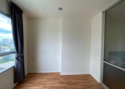 Empty bedroom with wooden floor and a window