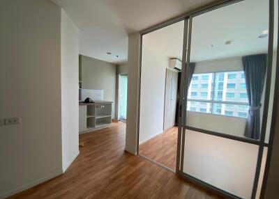 Living room with wooden flooring and large windows