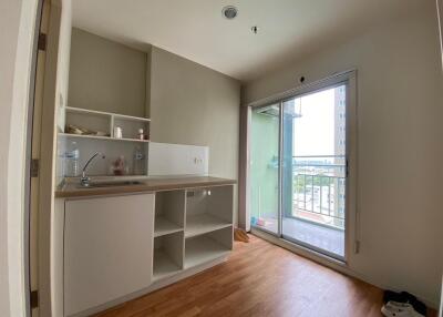 Compact kitchen with open shelving and balcony access