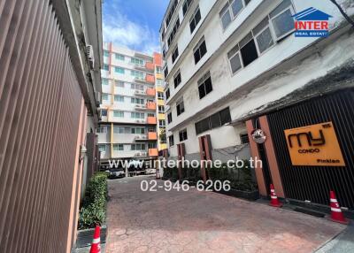 Main entrance of a condominium building with contact information