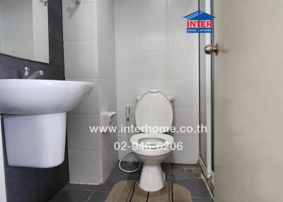 Small bathroom with a toilet, sink, and tiled floor