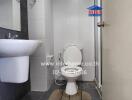 Small bathroom with a toilet, sink, and tiled floor