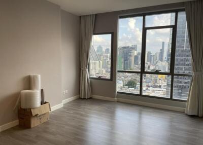 Spacious living room with large windows and city view