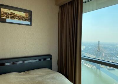 Bedroom with a view of a city and river