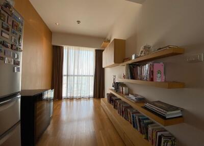 Room with bookshelves and large window