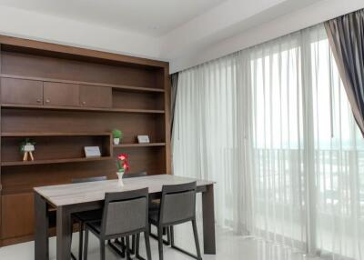 Modern dining area with table, chairs, and a built-in bookcase