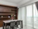 Modern dining area with table, chairs, and a built-in bookcase