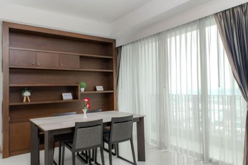 Modern dining area with table, chairs, and a built-in bookcase