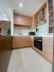 Modern kitchen with wooden cabinets and built-in appliances