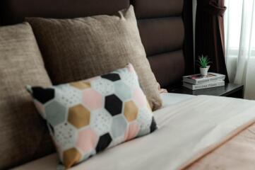 Cozy bedroom with decorative pillows and bedside table