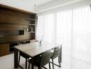 Bright dining area with large windows and a wooden dining table