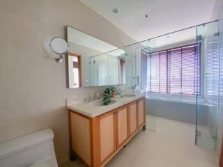 Modern bathroom with wooden accents and large mirror