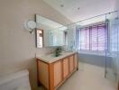 Modern bathroom with wooden accents and large mirror