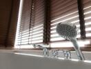 Modern bathroom with blinds and silver shower head