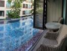 Balcony view with table and chairs overlooking a pool