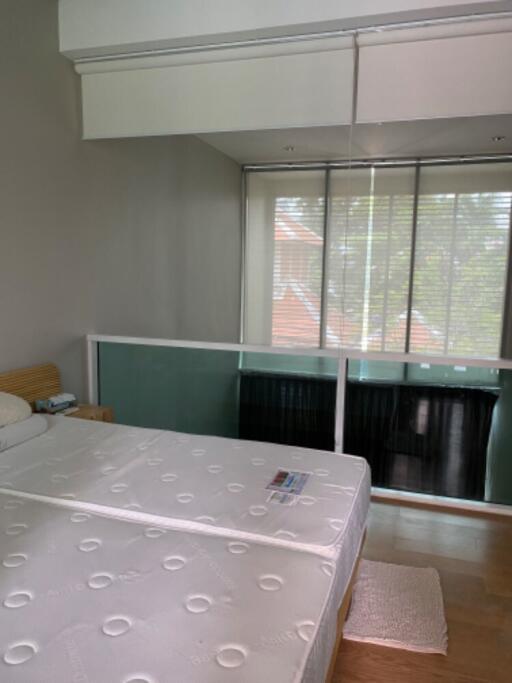 Loft bedroom with bed and window view