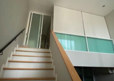 Staircase leading to a room with a glass partition