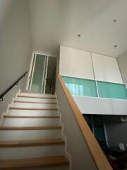 Staircase leading to a room with a glass partition