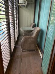 Balcony with wicker chairs and a small table