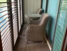 Balcony with wicker chairs and a small table