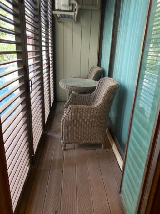 Balcony with wicker chairs and a small table