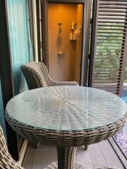 Photo of a balcony with wicker furniture and a view of a pool