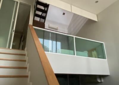 Modern living space with mezzanine and staircase