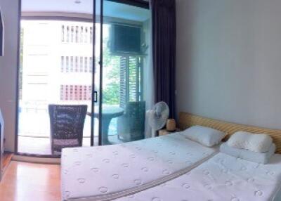 Spacious bedroom with large glass doors leading to a balcony