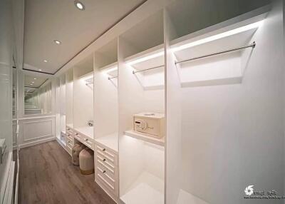 Spacious walk-in closet with built-in storage shelves and hanging rods