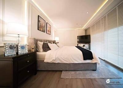 Spacious and well-lit bedroom with modern decor