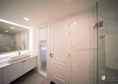 Modern bathroom with white interior and large mirror