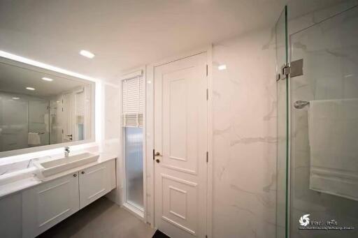 Modern bathroom with white interior and large mirror