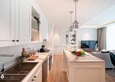 Modern kitchen with marble countertops and an open living area