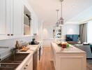 Modern kitchen with marble countertops and an open living area