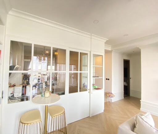 Spacious living area with glass partition and natural lighting