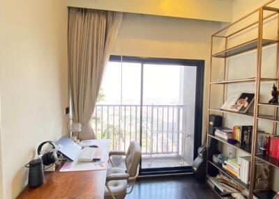 Home office with desk, chair, shelves and balcony