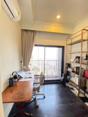 Home office with desk, chair, shelves and balcony