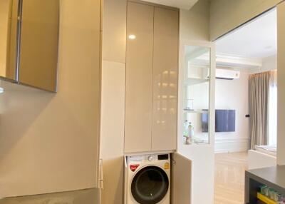 Compact laundry area with washing machine in a modern apartment