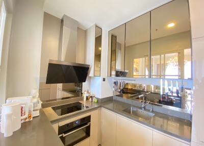 Modern kitchen with appliances and reflective cabinetry