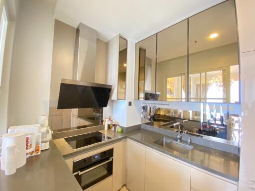 Modern kitchen with appliances and reflective cabinetry